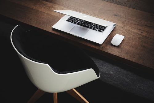 Laptop raised to eye level on an ergonomic desk