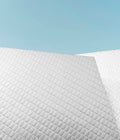 Ergonomic memory foam neck pillow on a bed