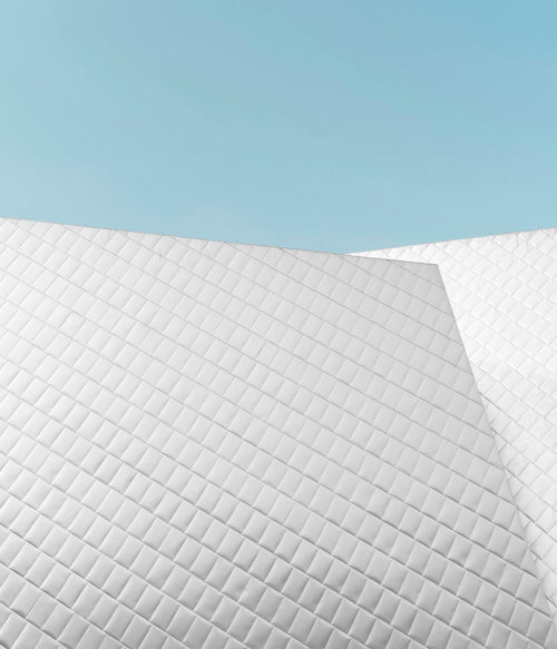 Ergonomic memory foam neck pillow on a bed